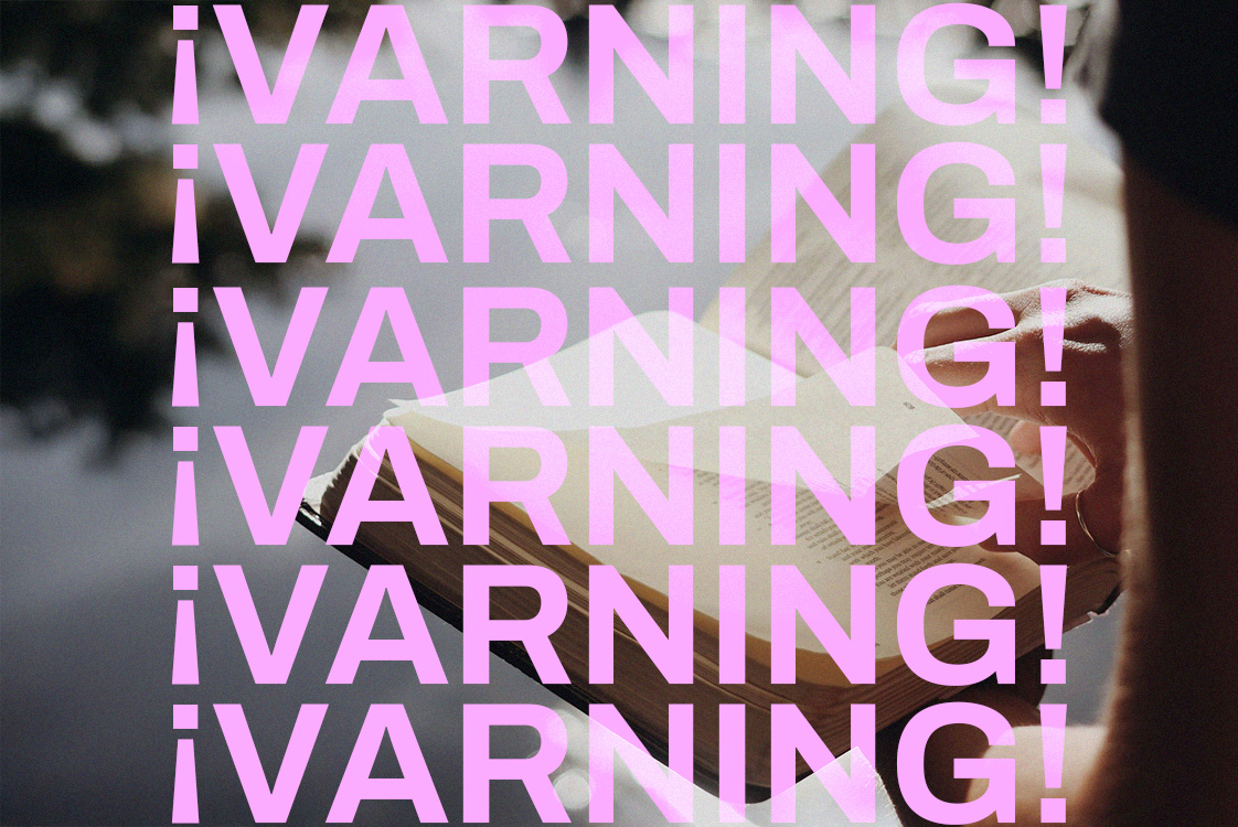 Varningstext framför en bibel.